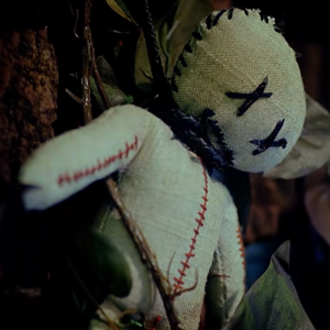 voodoo doll pinned to a tree
