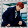 Jongho with red hair sitting leaned over square stamp