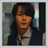 Kyubin with long hair wearing a suit looking at the viewer square stamp