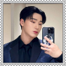 San in a blue suit taking a mirror selfie square stamp