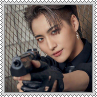 Seonghwa smirking and pointing a gun just past the camera square stamp